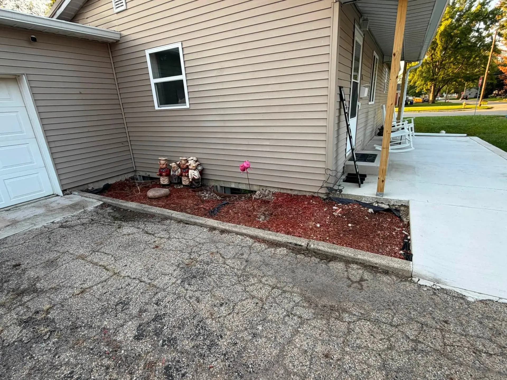 Mulch bed converted to decorative rock — before